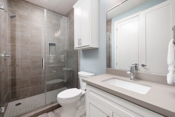 A toilet bowl next to a sink