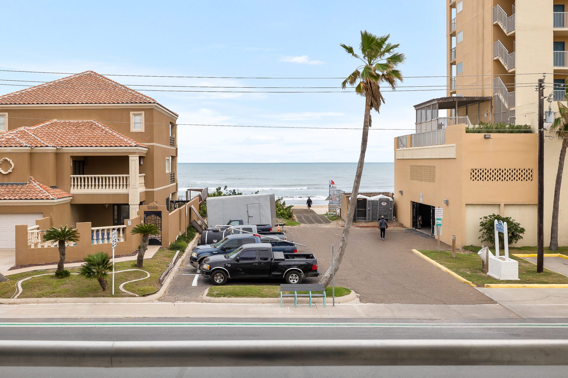 A spacious parking lot between two properties