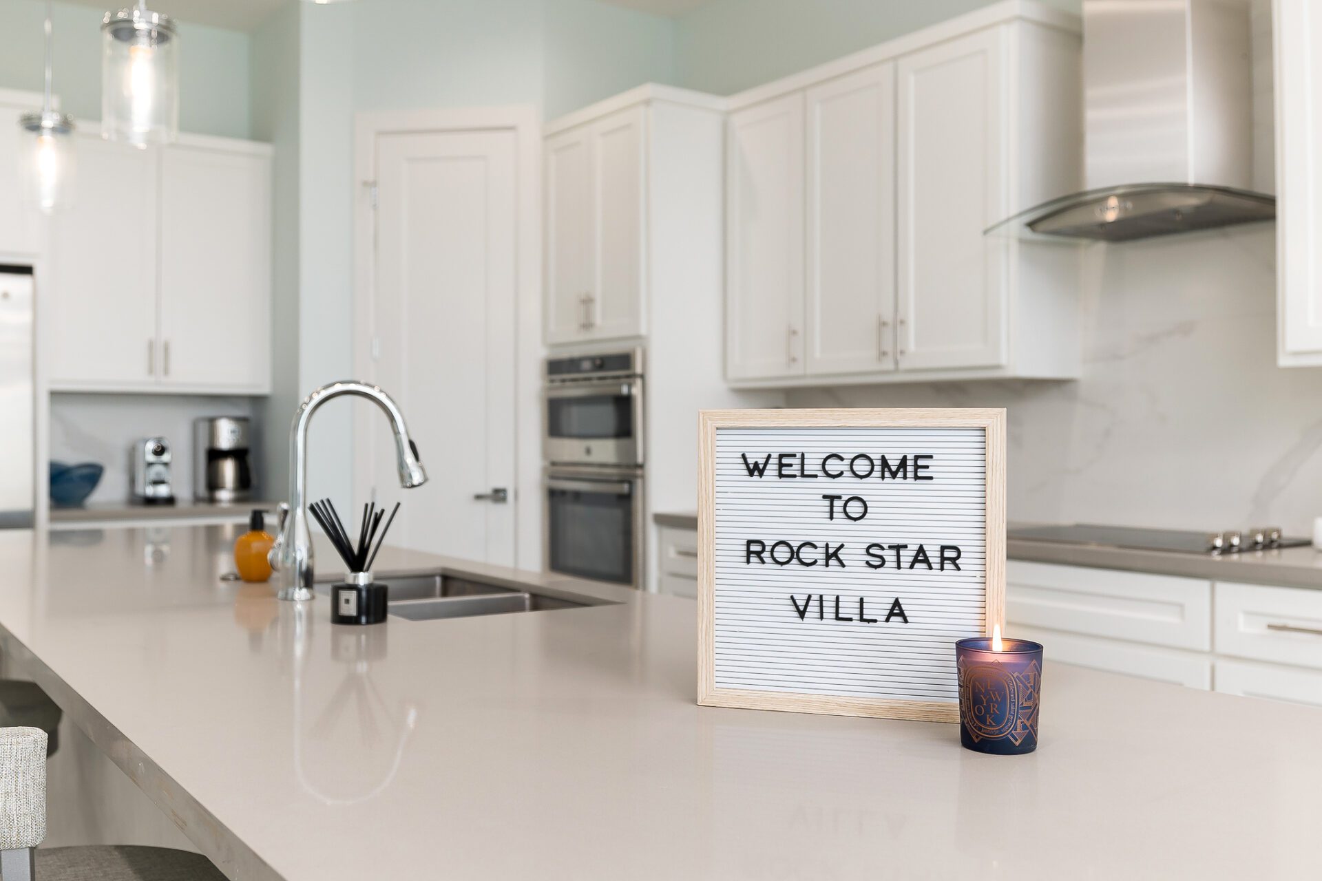 A kitchen with a Rock Star Villa signage