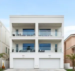 A white apartment next to an orange house